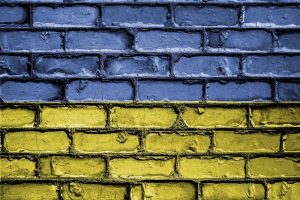 Brick wall painted to look like the Ukraine flag